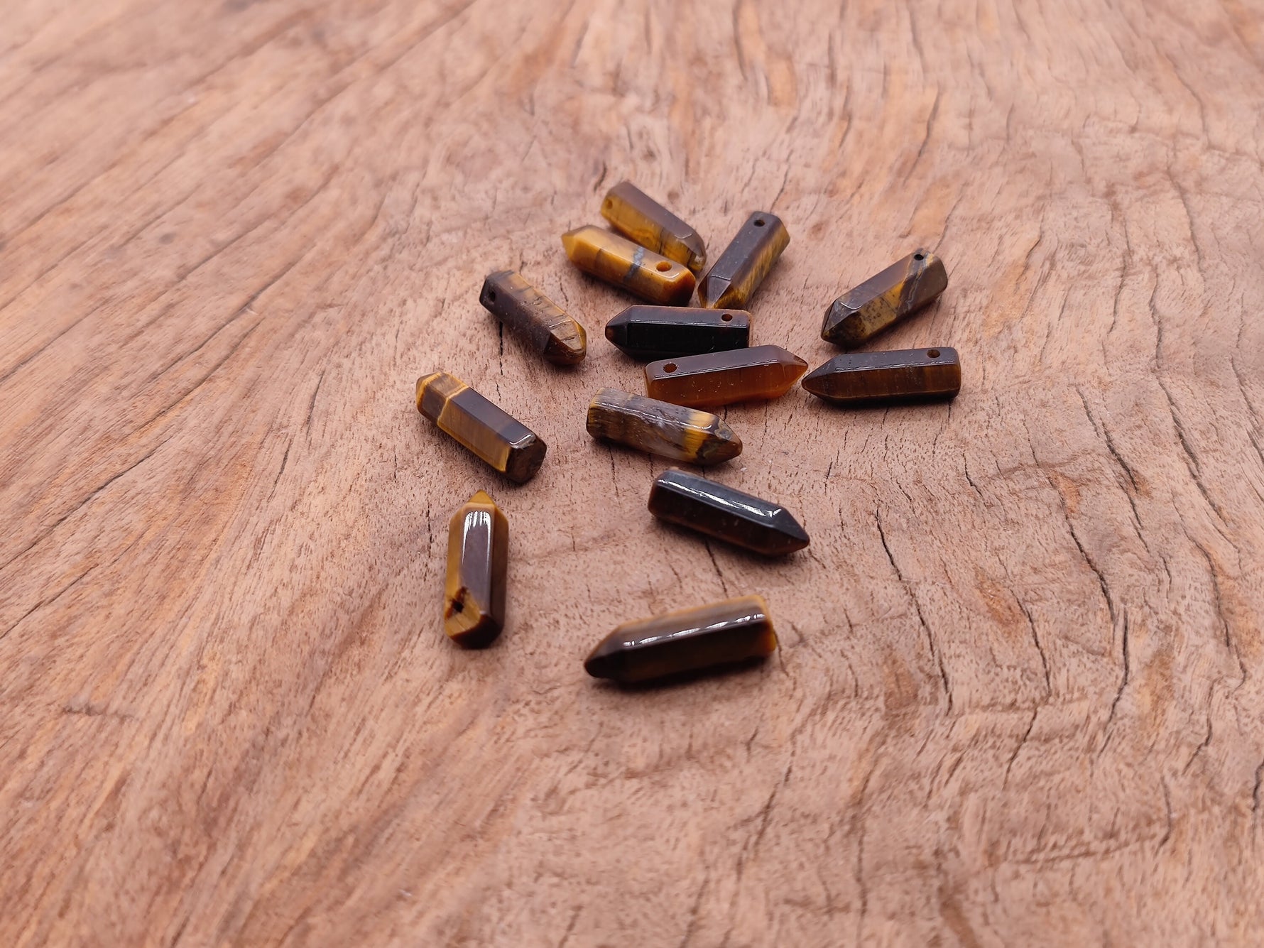 Tiger Eye crystal pendant with drilled point hole, featuring warm brown and golden hues, from GemstoneGO's gemstone jewelry collection.