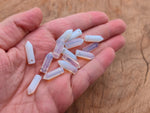 Opalite crystal pendant with drilled point hole, showcasing smooth, polished gemstone from GemstoneGO.