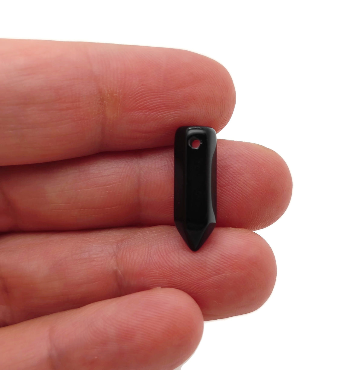 Obsidian point hole crystal pendant with drilled crystal point, showcasing smooth black gemstone with natural facets and drilled hole for jewelry.