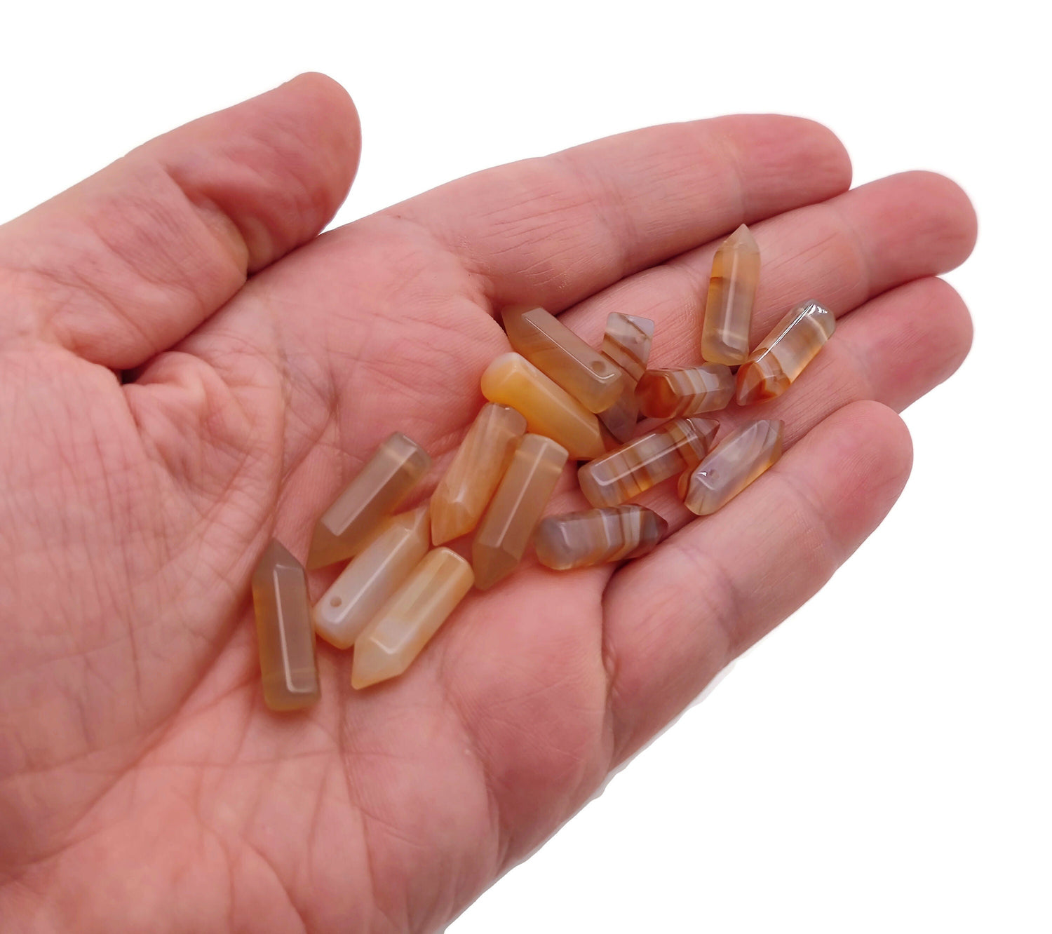 Carnelian crystal pendant with drilled point, showcasing vibrant orange-red gemstone from GemstoneGO.