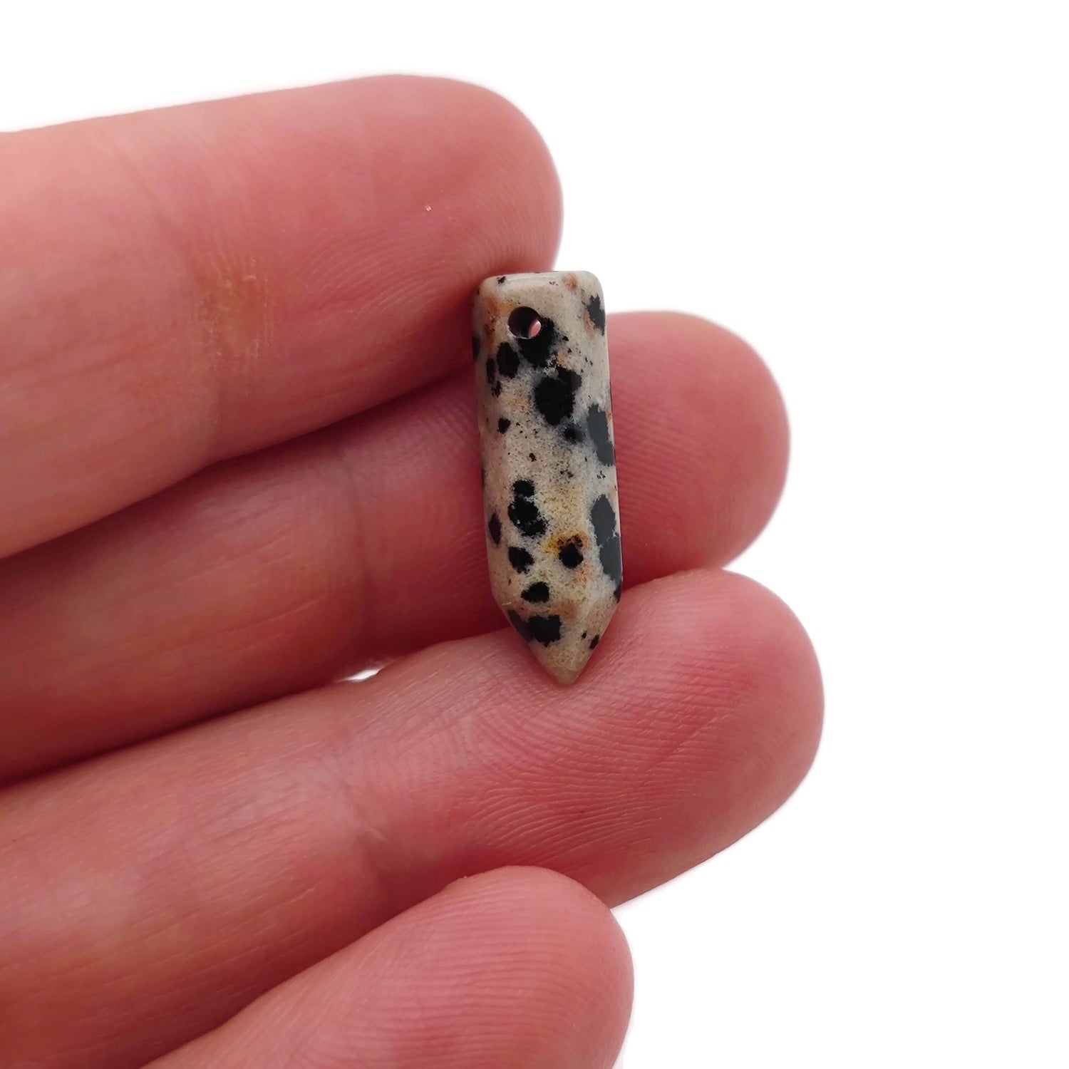 Dalmatian Jasper crystal point pendant with drilled hole, showcasing black and cream spotted stone from GemstoneGO.