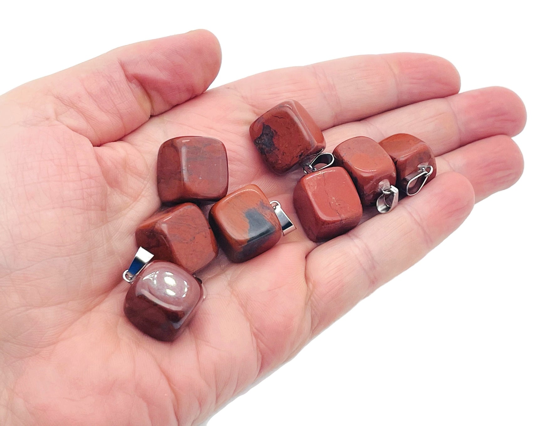 Red Jasper tumbled crystal pendant from GemstoneGO, showcasing a smooth, polished red jasper stone with a silver bail.