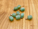A smooth aventurine tumbled gemstone pendant with natural green coloration, featuring a simple silver bail for necklace attachment.