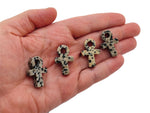 Dalmatian Jasper Anka crystal carving depicting gemstone ankhs, 30mm, from GemstoneGO featuring distinctive black spots on cream background.
