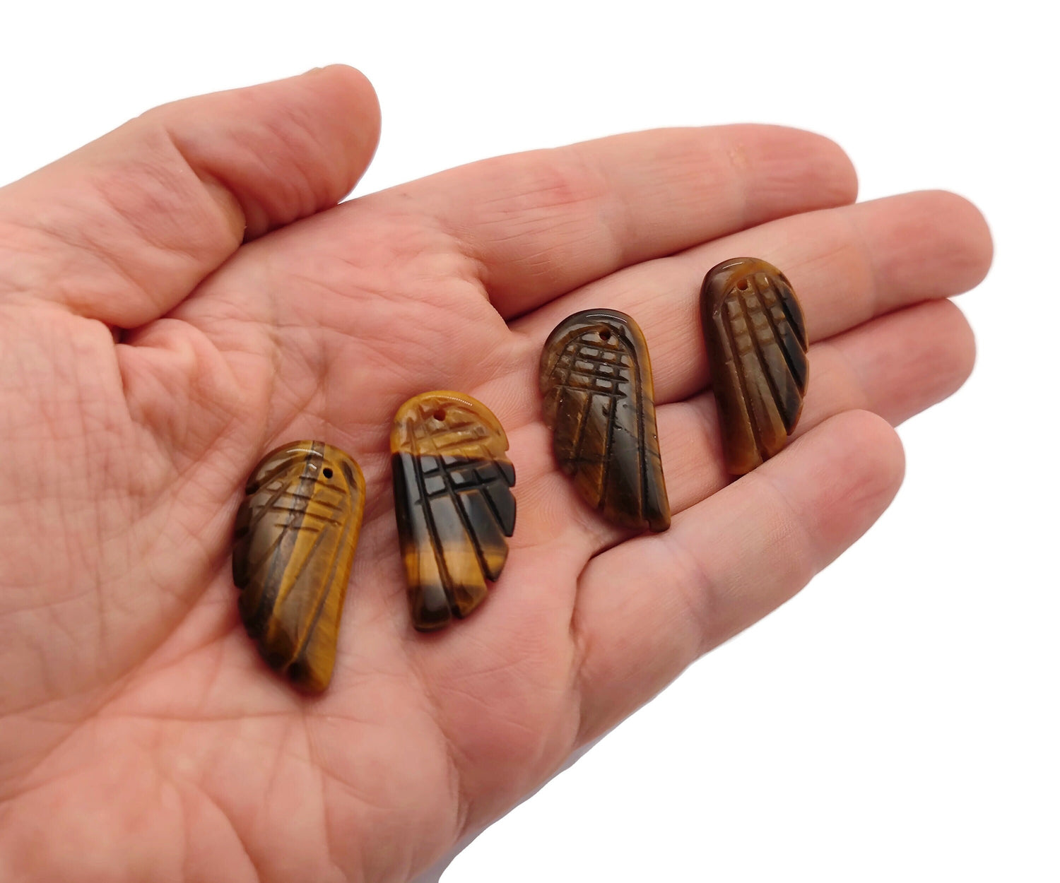 Tiger Eye angel wing crystal pendant featuring a hole for jewelry, with detailed gemstone and wing design by GemstoneGO.