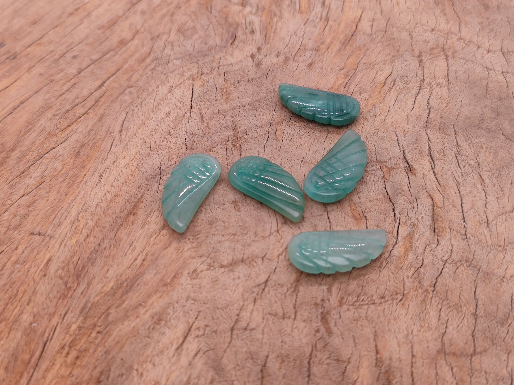 Aventurine angel wing crystal pendant with hole charm, showcasing the detailed green gemstone wing design.