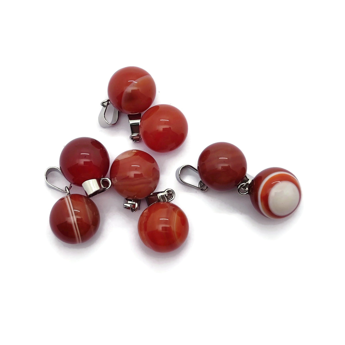 Carnelian crystal ball pendant showcasing a polished round gemstone used for jewelry making, by GemstoneGO.