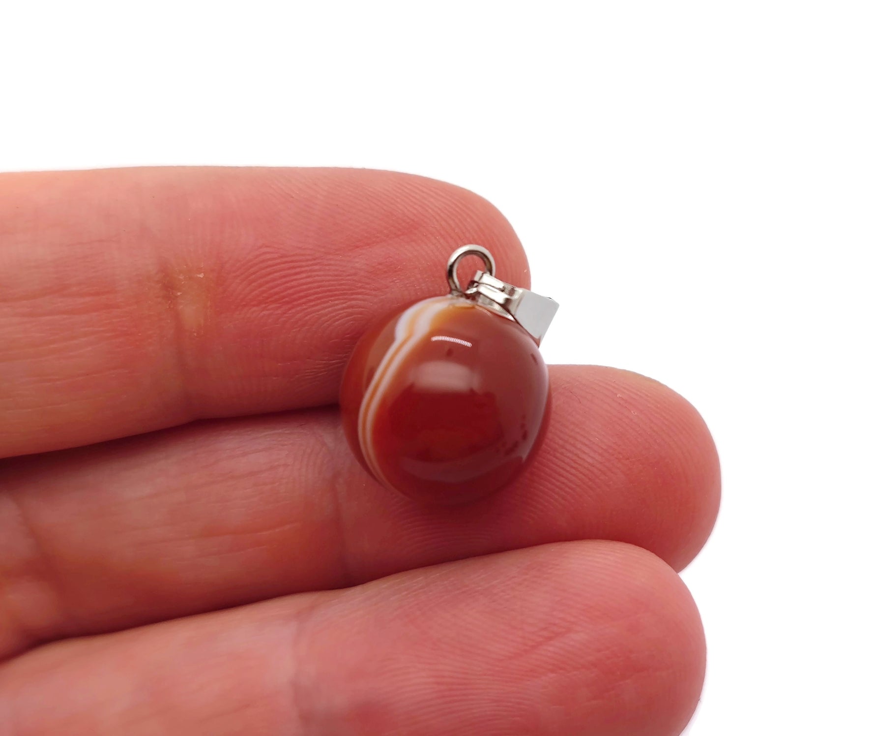 Round carnelian ball crystal pendant from GemstoneGO, showcasing a vibrant orange gemstone for jewelry making.
