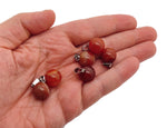 Carnelian crystal ball pendant with polished round gemstone for jewelry making, showcasing vibrant orange-red color and smooth surface.