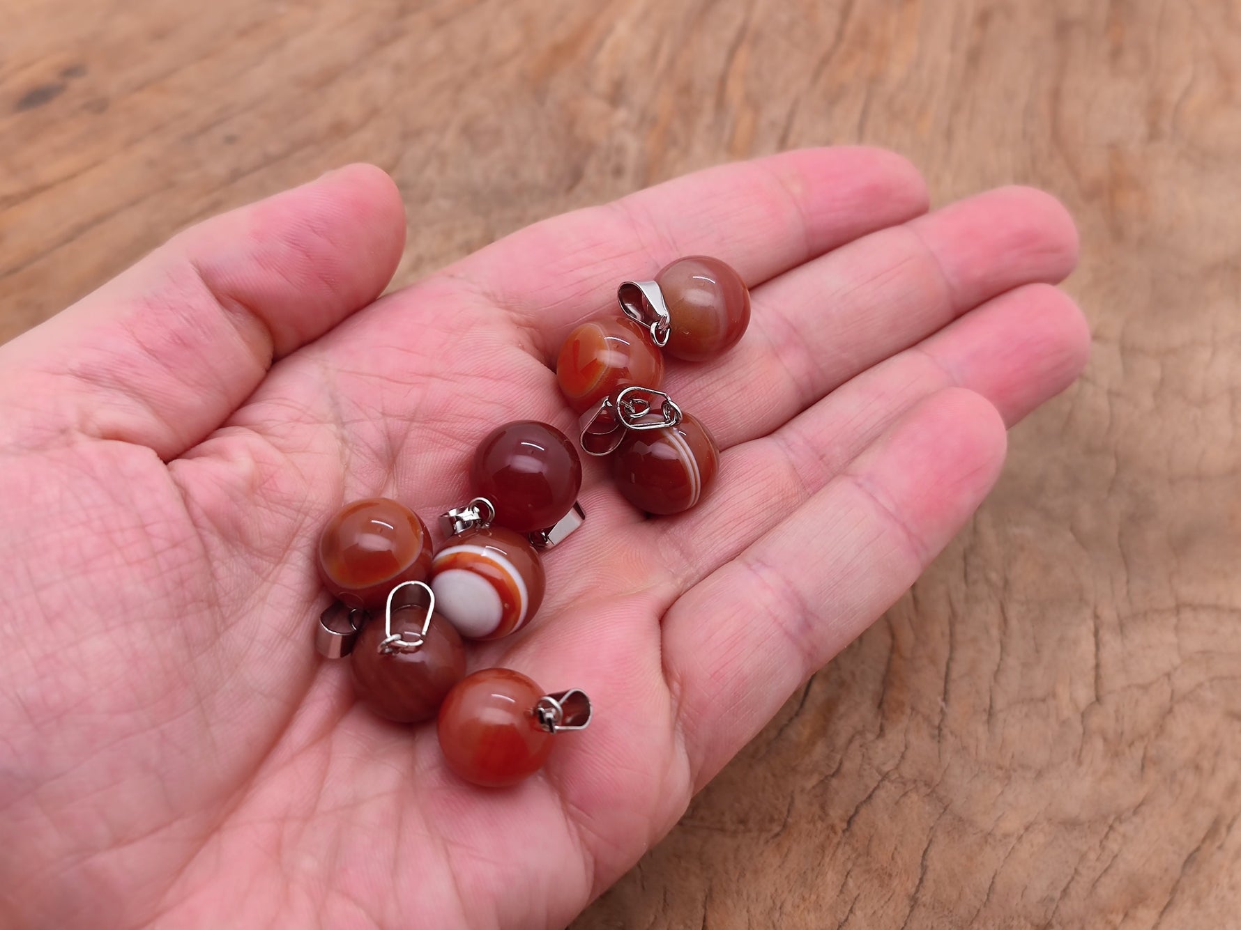 Carnelian crystal ball pendant by GemstoneGO, round gemstone jewelry making pendant with polished orange-red stone.