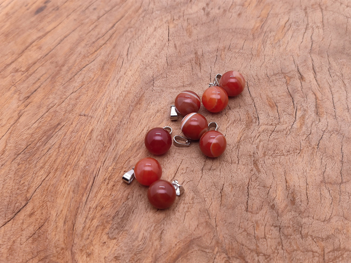 Carnelian crystal ball pendant from GemstoneGO, round gemstone jewelry making pendant with a smooth polished surface.