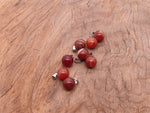 Carnelian crystal ball pendant from GemstoneGO, round gemstone jewelry making pendant with a smooth polished surface.