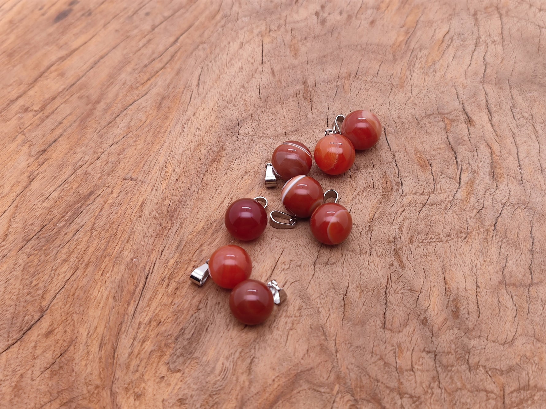 Carnelian crystal ball pendant from GemstoneGO, round gemstone jewelry making pendant with a smooth polished surface.