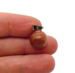 Goldstone crystal ball pendant by GemstoneGO, round gemstone jewelry making accessory, showcasing a polished goldstone sphere.