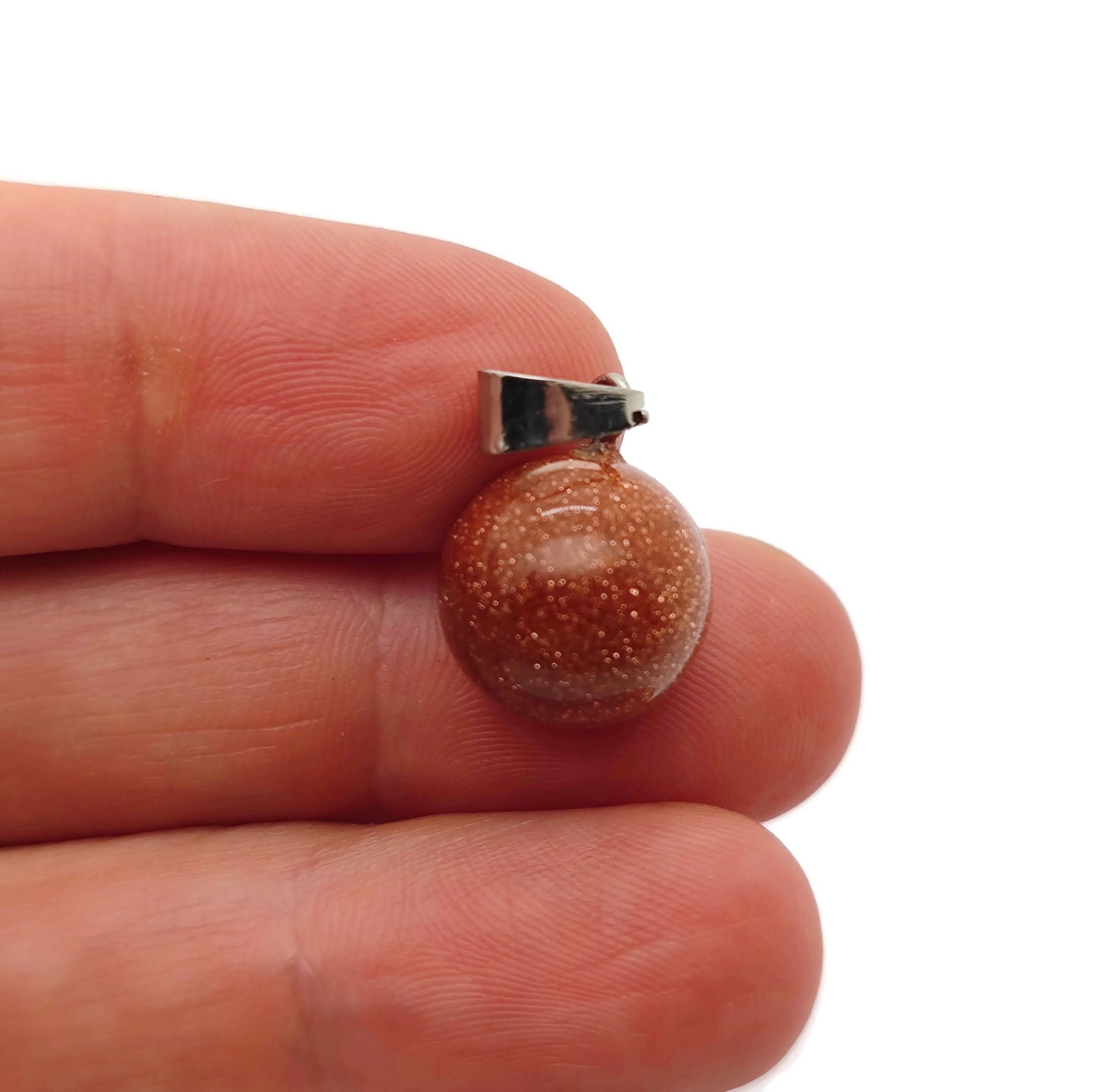 Goldstone crystal ball pendant by GemstoneGO, round gemstone jewelry making accessory, showcasing a polished goldstone sphere.
