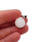 White jade crystal ball pendant from GemstoneGO, round jewelry-making pendant showcasing smooth, polished white jade sphere.