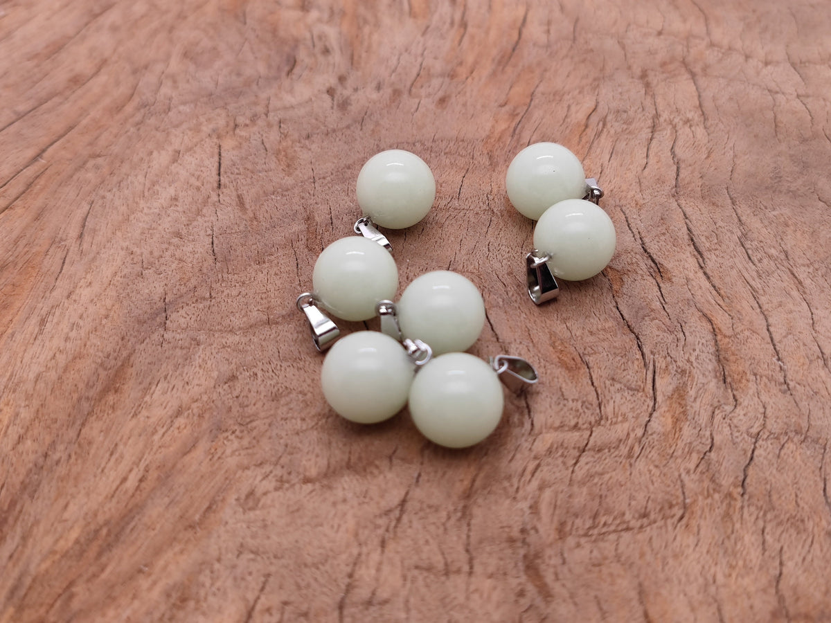 Luminous crystal round ball pendant from GemstoneGO, perfect for jewelry making, showcasing a clear, polished gemstone.