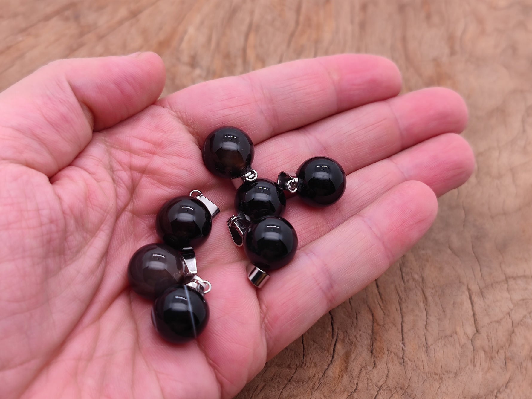 Black agate crystal ball pendant with smooth round shape, gemstone jewelry making accessory from GemstoneGO.