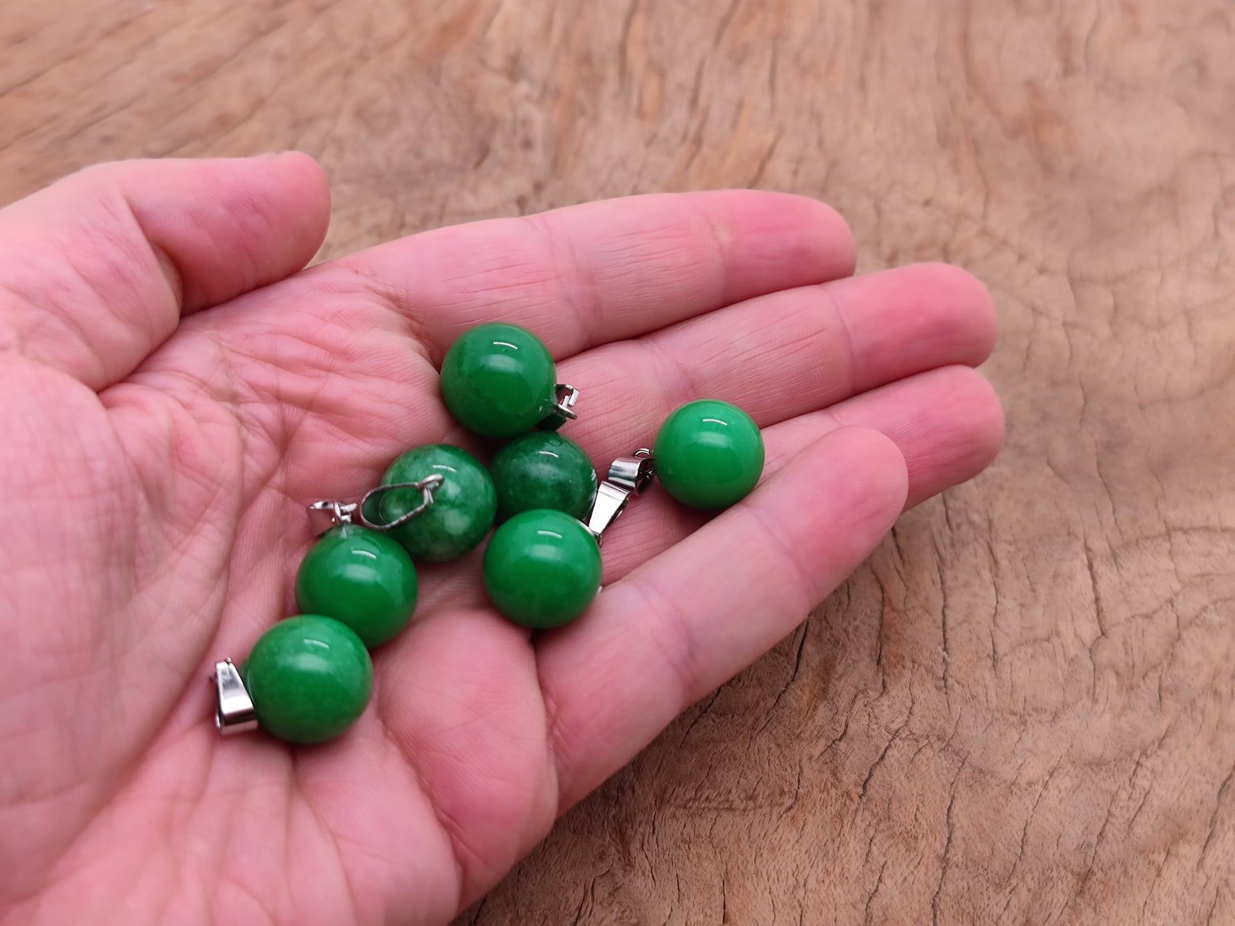 Green agate crystal ball pendant with polished round shape, perfect for jewelry making, from GemstoneGO.