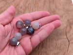 Gray agate crystal ball pendant with a smooth round shape, ideal for jewelry making and gemstone jewelry designs.