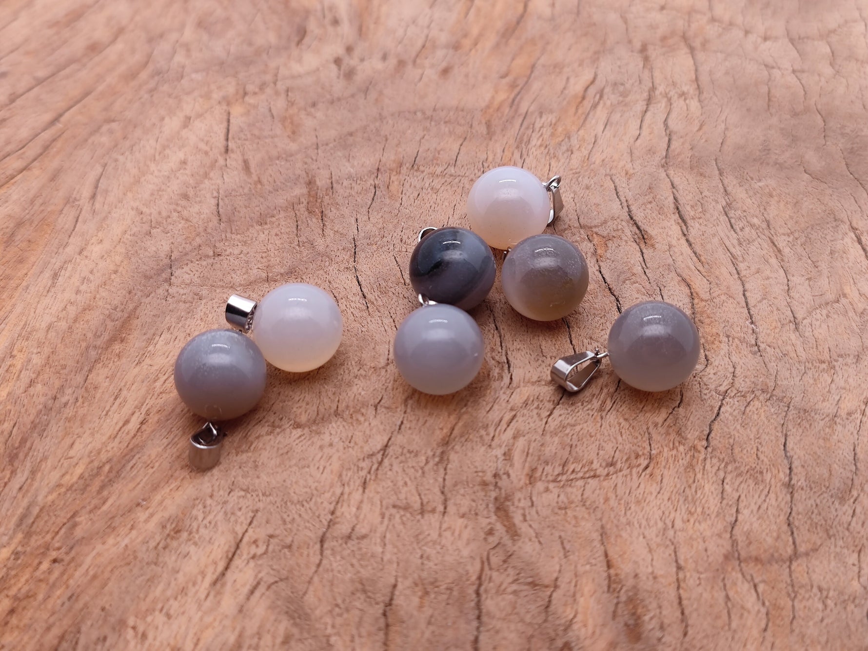 Grey agate crystal ball pendant with polished round shape, perfect for jewelry making by GemstoneGO.