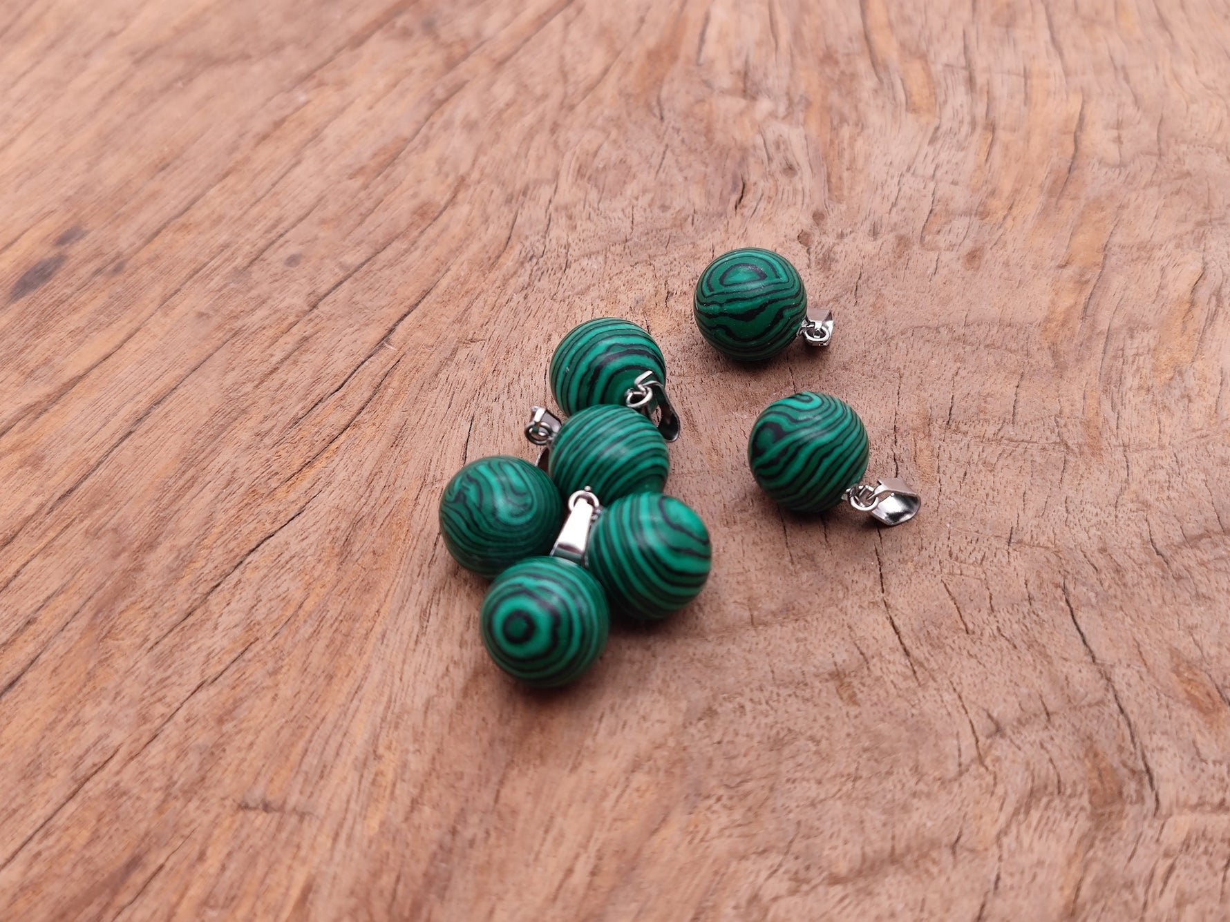 Synthetic malachite crystal ball pendant with a polished round shape, ideal for jewelry making by GemstoneGO.