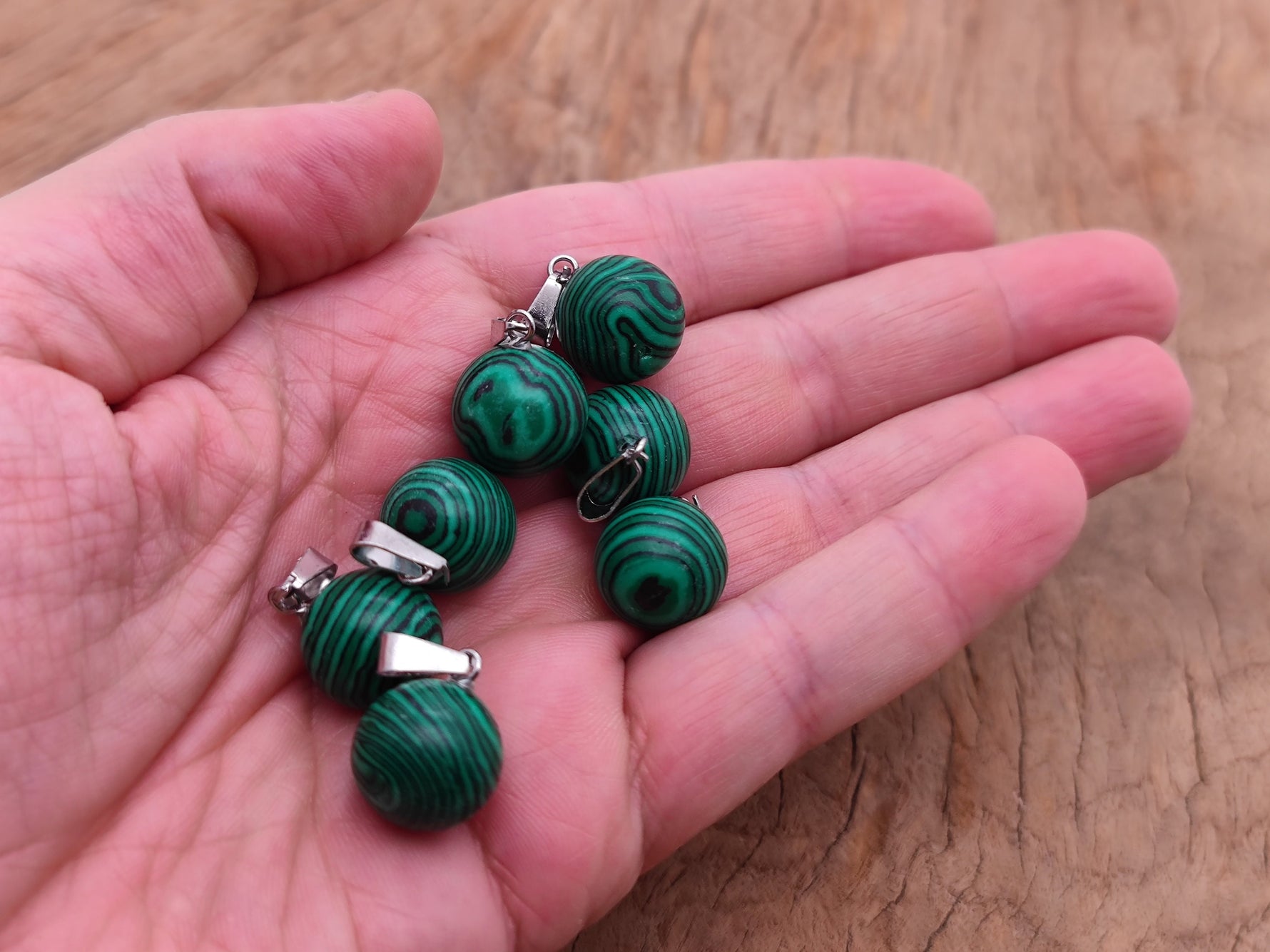 Round synthetic malachite ball pendant with a smooth, polished surface for jewelry making, showcasing vibrant green and black banding.