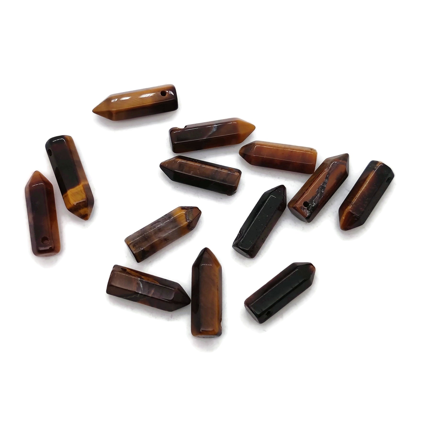 Tiger Eye crystal pendant with drilled point, showcasing rich golden-brown bands and polished surface, from GemstoneGO.