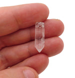 Clear Quartz point crystal pendant with drilled hole, showcasing a natural, transparent quartz gemstone for jewelry making.