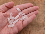 Clear quartz point crystal pendant with drilled hole, showcasing a natural, polished gemstone from GemstoneGO.