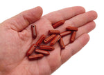 Red Jasper crystal pendant with drilled point, showcasing natural gemstone with vibrant red color and polished surface.