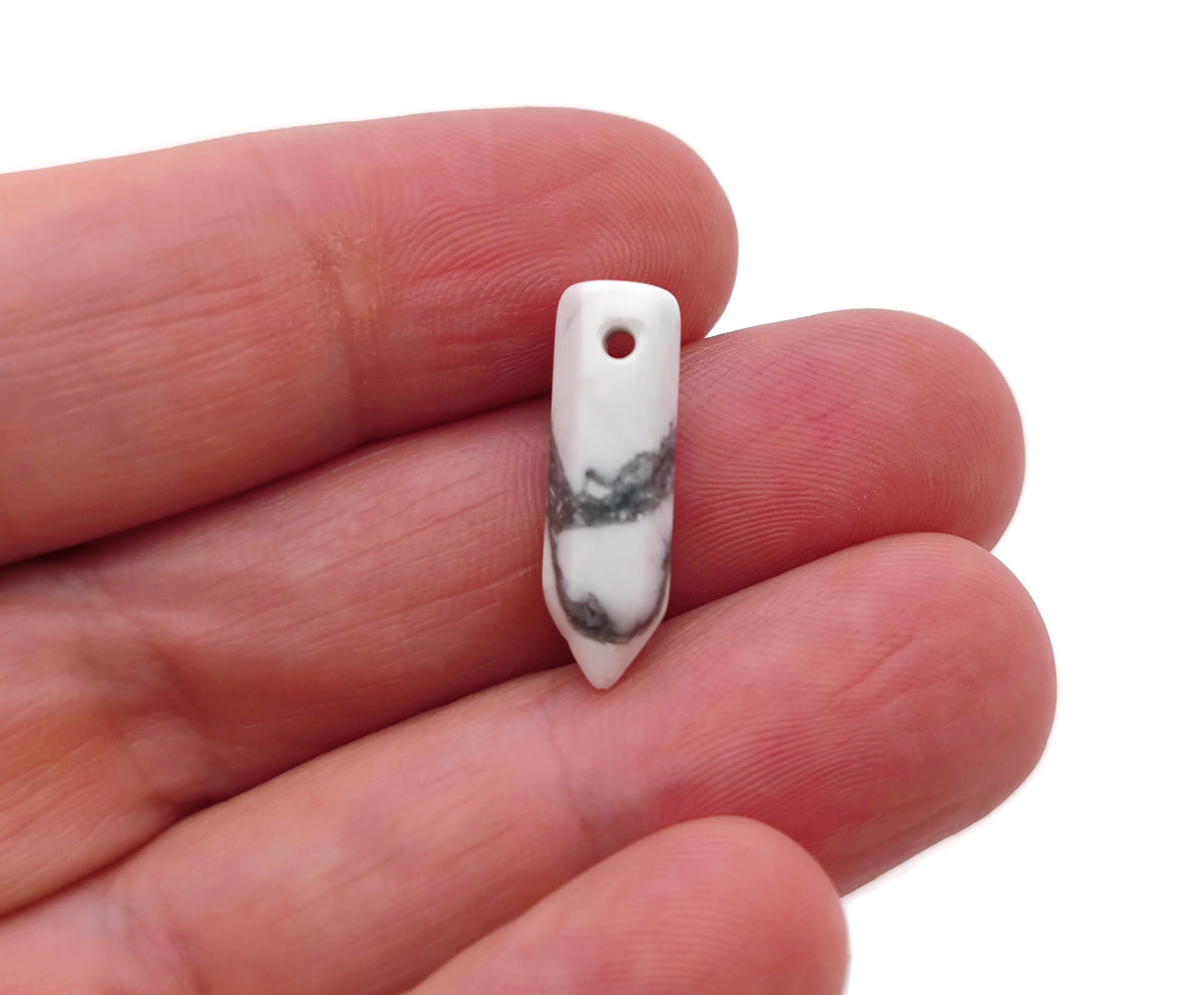 Drilled howlite crystal point pendant with natural white and gray veining, crafted by GemstoneGO, showcasing a smooth, polished crystal tip.