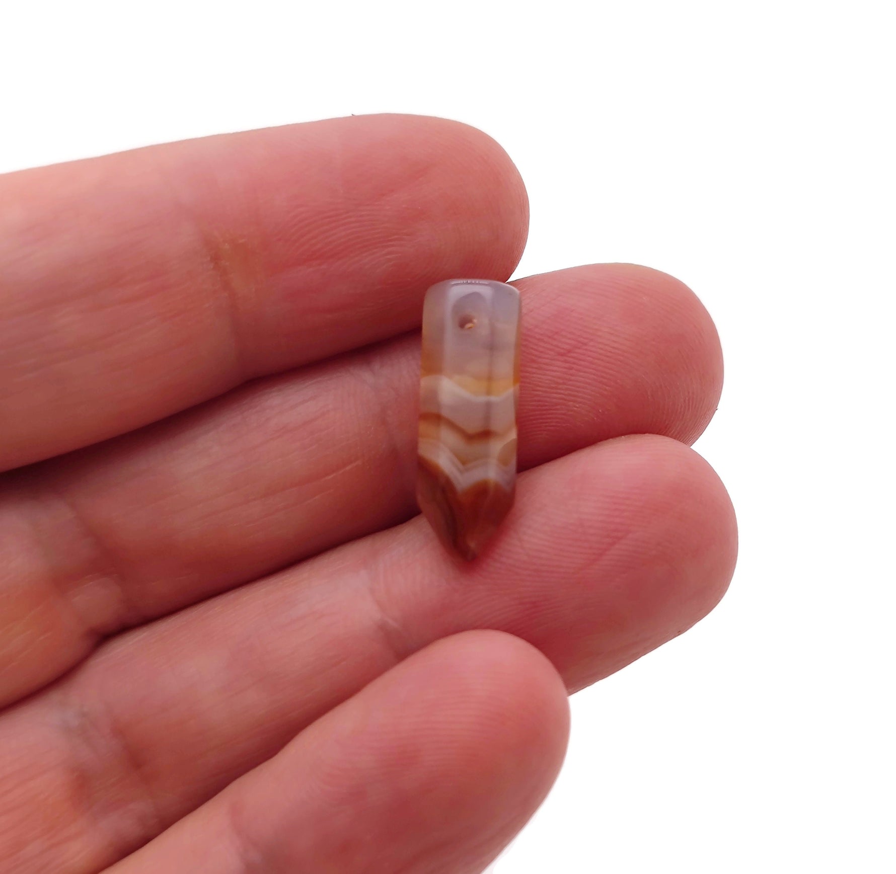 Carnelian point hole crystal pendant from GemstoneGO, drilled gemstone with vibrant orange color and natural crystal formation.