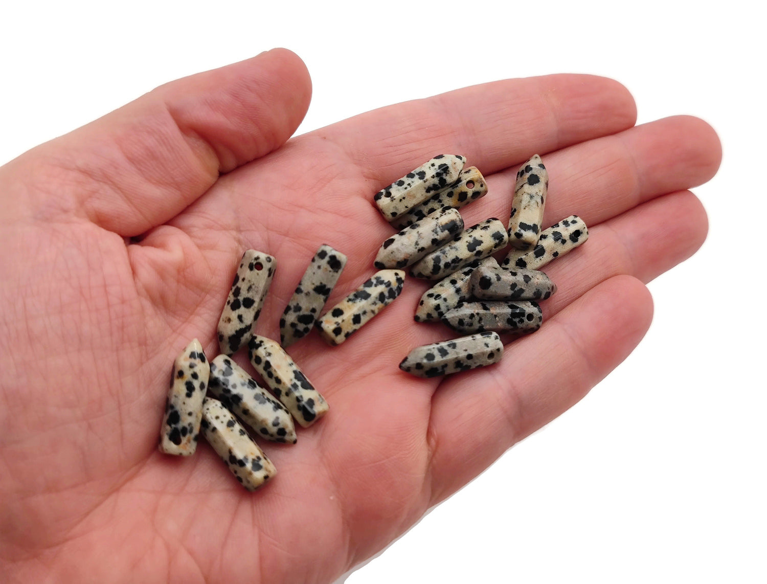 Dalmatian Jasper crystal point pendant with drilled hole, showcasing black and cream spotted pattern, from GemstoneGO.