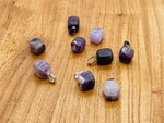 Amethyst tumbled gemstone pendant from GemstoneGO featuring a smooth purple stone with silver bail on a white background.