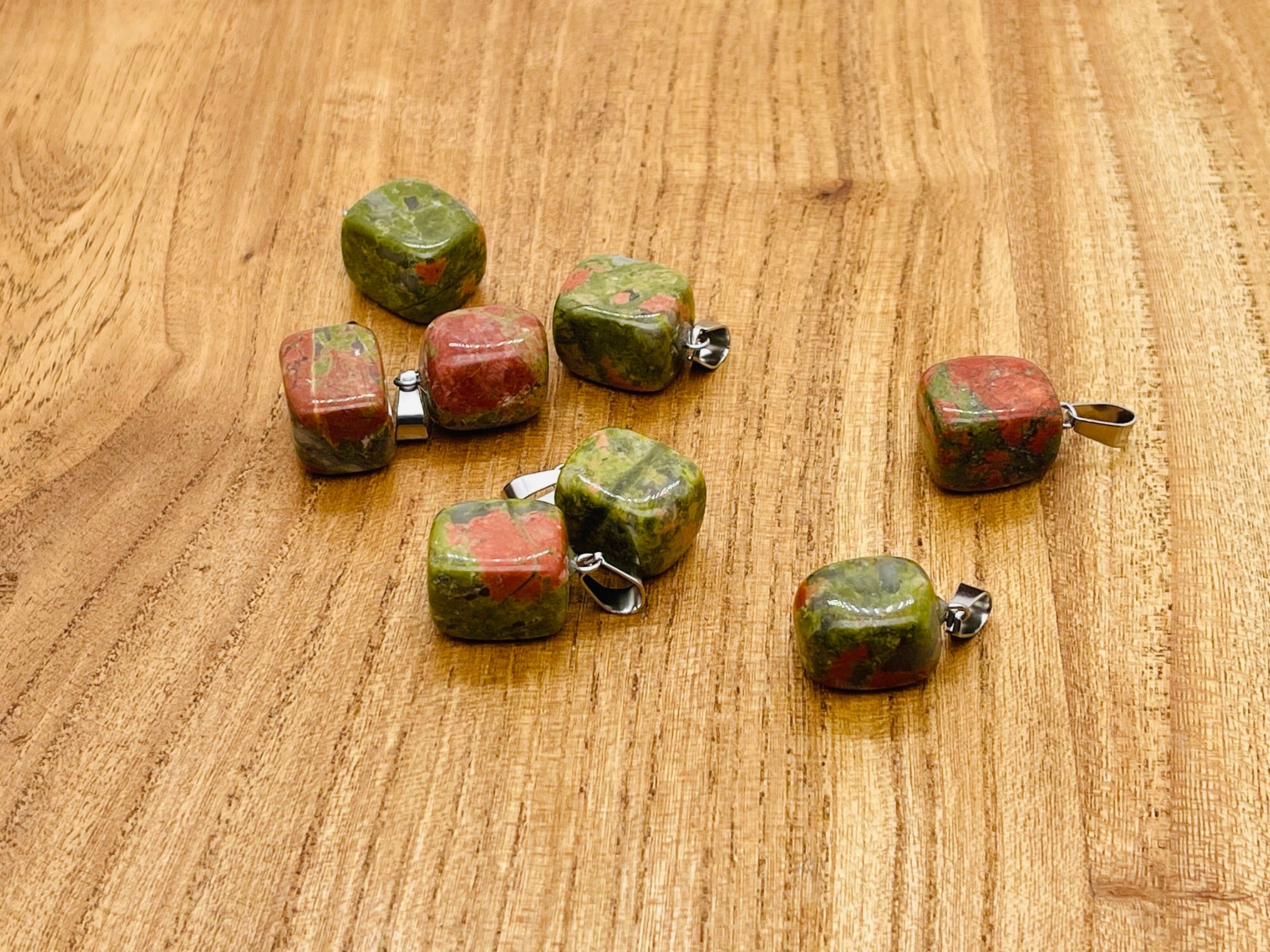 Unakite tumbled crystal pendant from GemstoneGO featuring a polished love stone with green and pink hues.