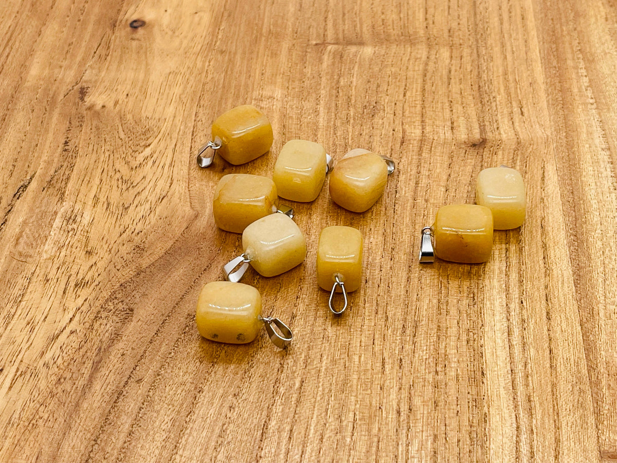 Yellow jade tumbled gemstone pendant from GemstoneGO featuring a smooth, polished yellow jade stone on a simple cord necklace.