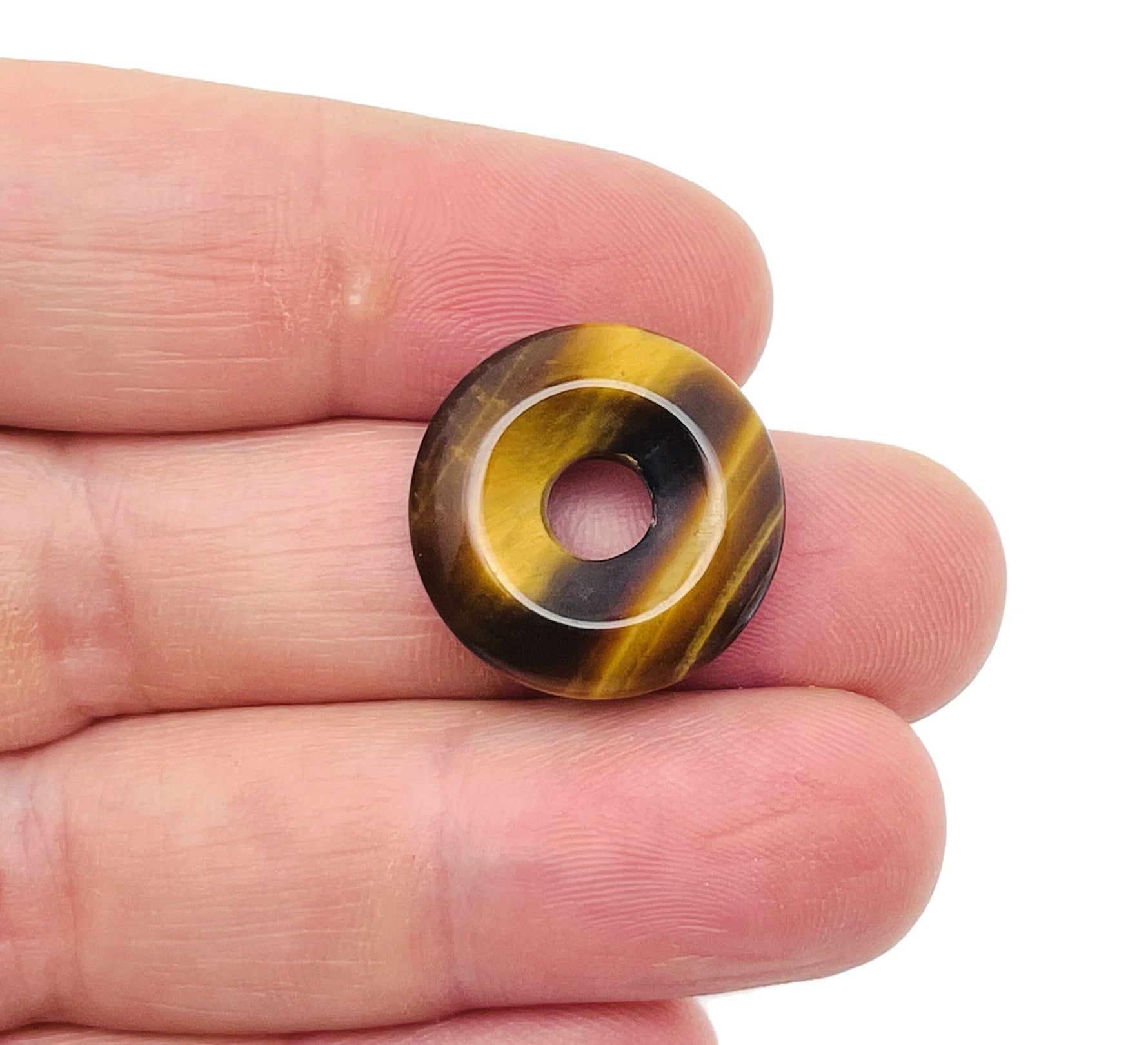 Tiger Eye Crystal Donut, 20mm Pi Stone by GemstoneGO, showcasing the smooth, polished gemstone with rich golden-brown hues and natural patterning.