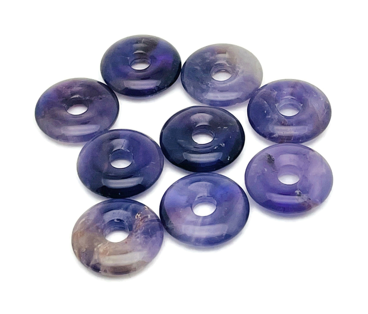 Amethyst crystal donut gemstone from GemstoneGO, 20mm Pi Stone with purple amethyst color and smooth polished surface.