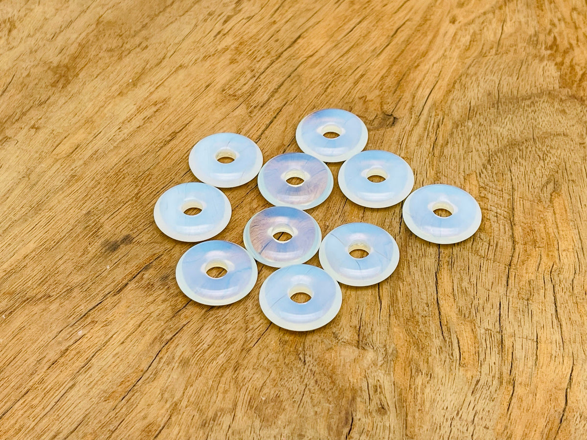 Opalite crystal donut pendant, 20mm Pi Stone from GemstoneGO, showcasing a smooth, polished opalite gemstone with a unique glow.