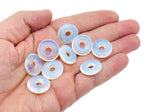 Opalite crystal donut pendant, 20mm Pi stone from GemstoneGO, showing its smooth, iridescent surface and rounded shape.