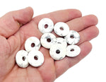 Howlite crystal donut pendant from GemstoneGO, 20mm Pi stone with white and gray marbled appearance, smooth round shape.