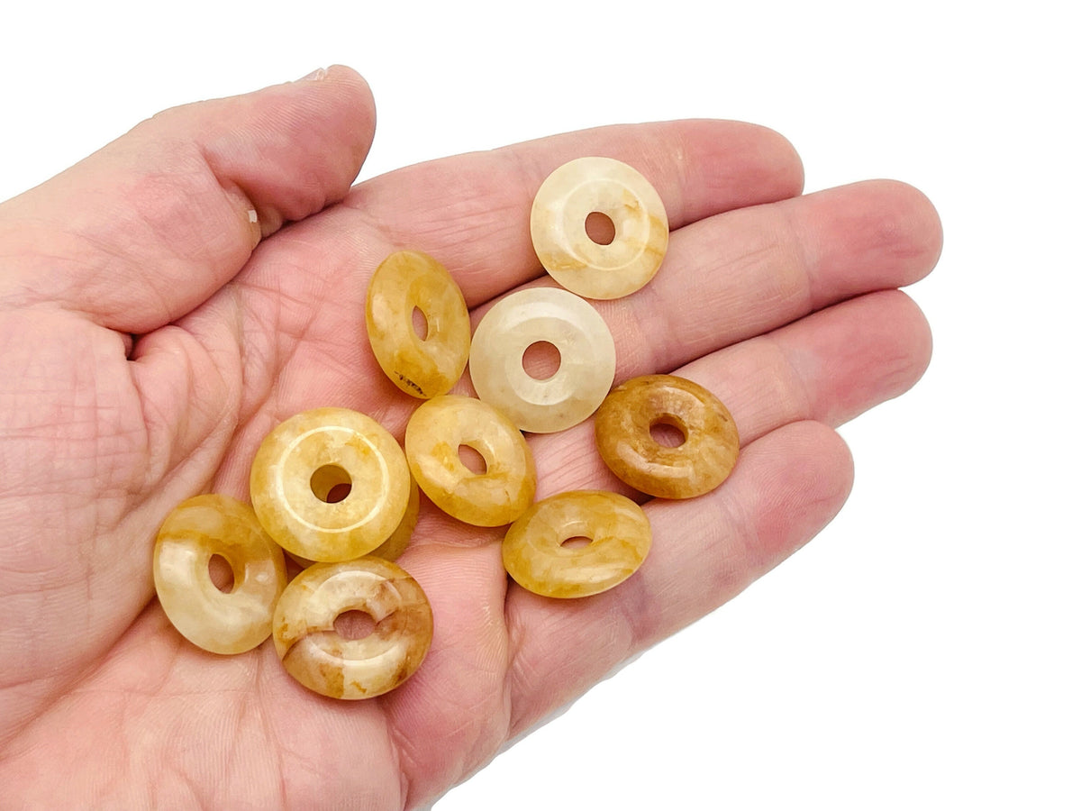 Yellow jade crystal donut pendant from GemstoneGO, 20mm Pi stone with polished yellow jade surface and circular shape.