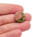 Round Unakite flat gemstone slab, vibrant green and pink crystal, showcasing smooth polished surface and natural mineral patterns.