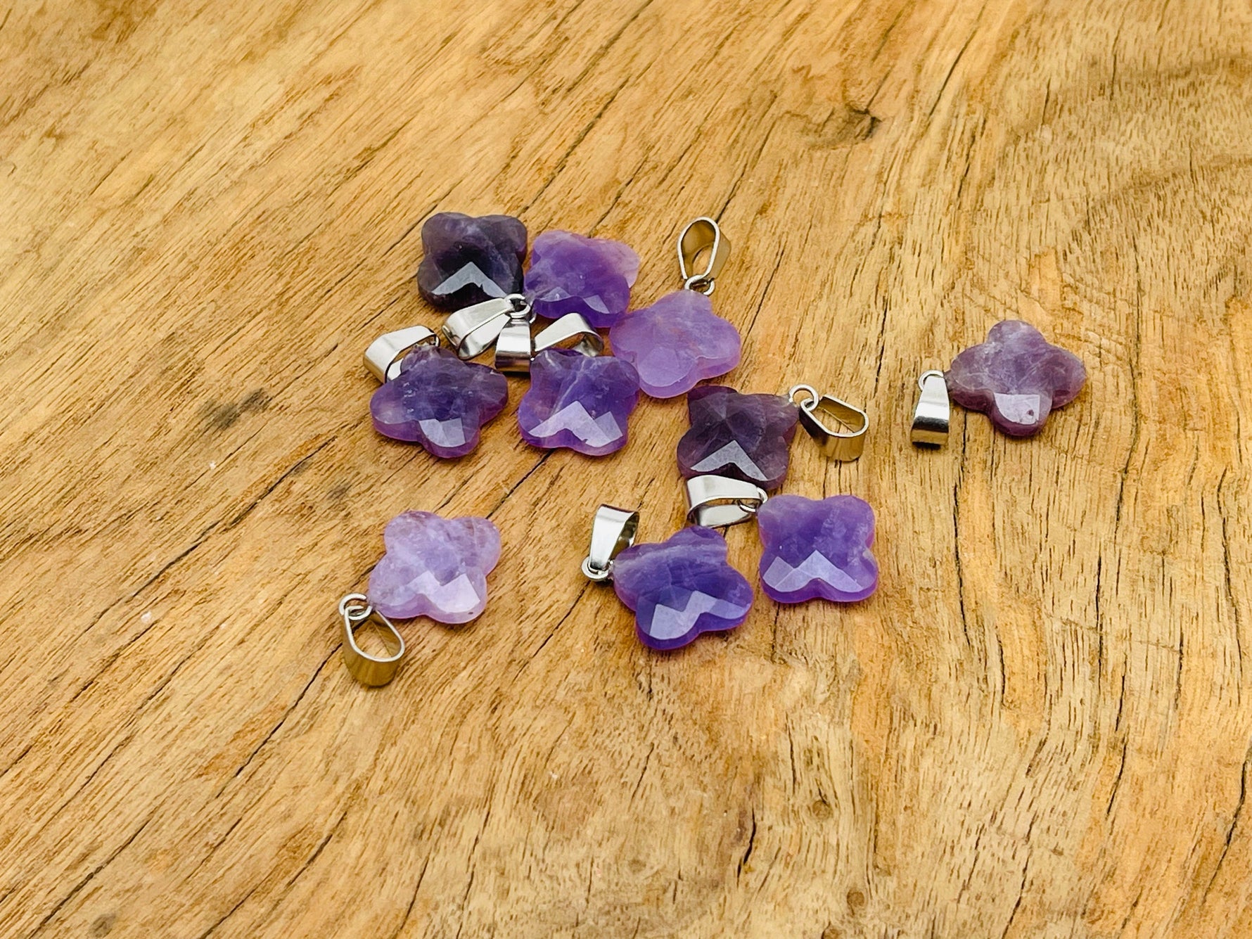 Amethyst four-leaf clover crystal pendant from GemstoneGO, ideal for DIY jewelry making, with purple gemstone and silver bail.