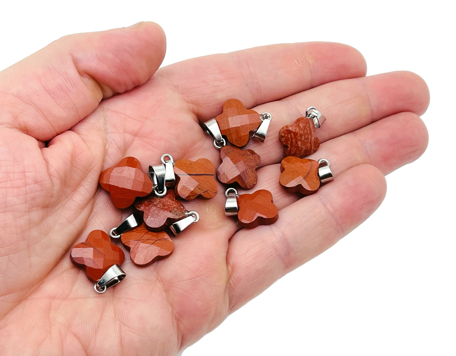 Red Jasper four-leaf clover crystal pendant for jewelry making by GemstoneGO, featuring a vibrant red gemstone and detailed design.