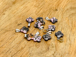 Rhodonite four-leaf clover crystal pendant from GemstoneGO, ideal for DIY jewelry making, featuring vibrant pink and black stone.