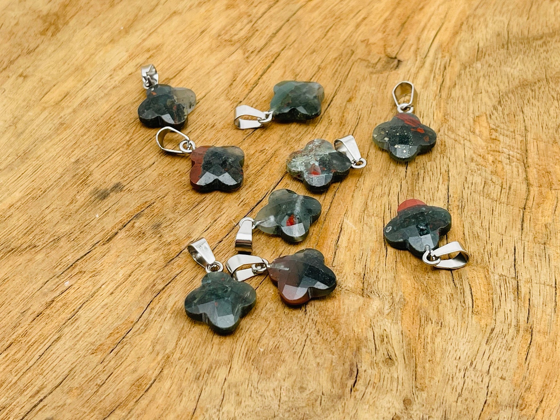 African Bloodstone four-leaf clover crystal pendant by GemstoneGO, showcasing a vibrant green bloodstone with a four-leaf clover shape.