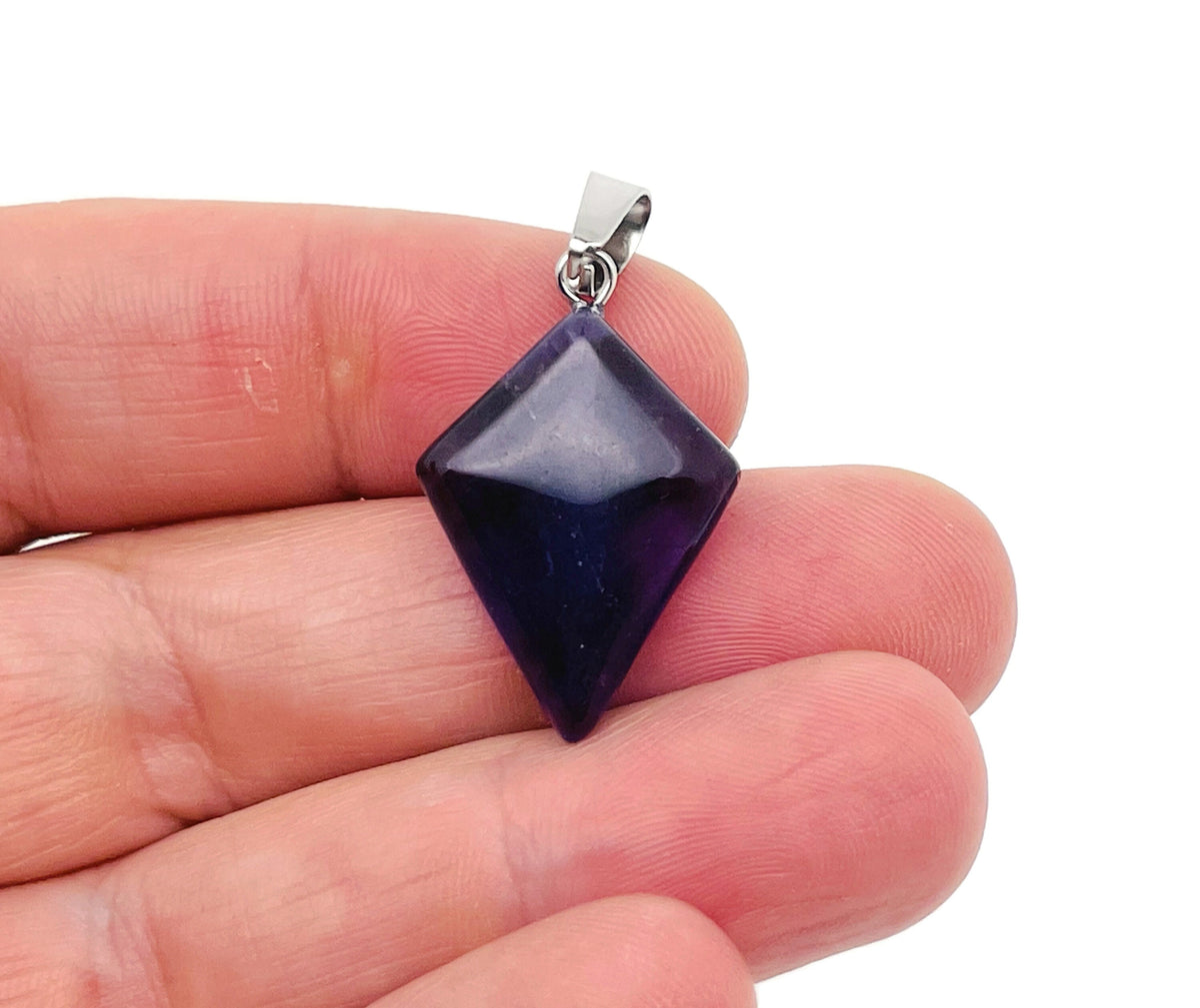 Amethyst triangle gemstone pendant from GemstoneGO showcasing a geometric purple amethyst pendant on a silver chain.