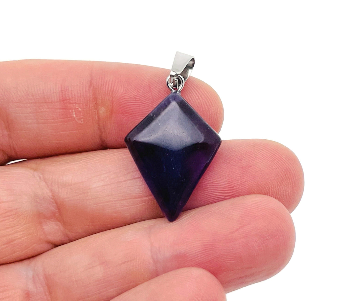 Amethyst triangle gemstone pendant from GemstoneGO showcasing a geometric purple amethyst pendant on a silver chain.